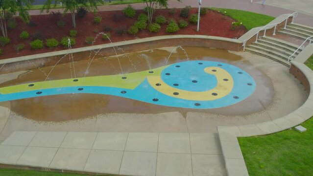 Aerial circle left to right of water fountain with scenic view