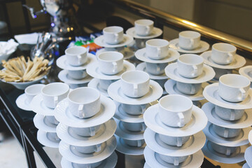 Set of coffee break lunch in the hotel restaurant during conference meeting, with tea and coffee catering, decorated banquet table with white tableware and metal tea maker machine boiler