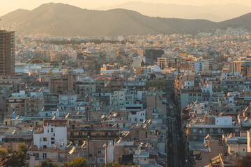 Fototapeta premium Piraeus city, Attica, beautiful panoramic view of Piraeus, Greece, with harbour and port, mountains and scenery beyond the city, seen from Prophet Helias Hill on Kastela Hill, sunset summer view