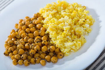 Homemade rice with spicy chickpeas served on white dish