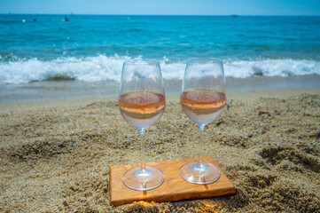 Cold rose wine from Provence served outdoor on white sandy beach Plage de Pampelonne near Saint-Tropez, France