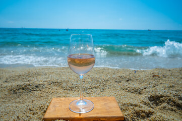 Cold rose wine from Provence served outdoor on white sandy beach Plage de Pampelonne near Saint-Tropez, France
