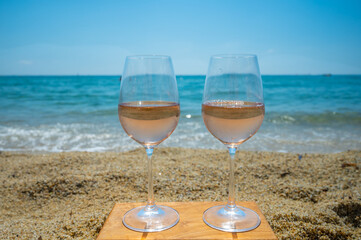 Cold rose wine from Provence served outdoor on white sandy beach Plage de Pampelonne near Saint-Tropez, France