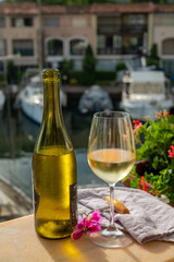 Drinking of cold white wine  with view on yacht harbour of Port Grimaud, summer vacation on French Riviera, France