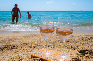 Cold rose wine from Provence served outdoor on white sandy beach Plage de Pampelonne near Saint-Tropez, France