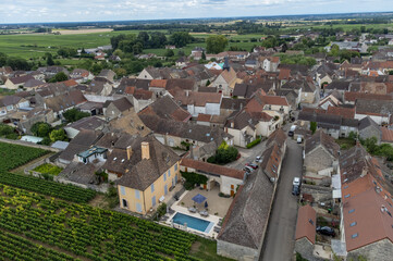 Aerial view on green vineyards and Puligny-Montrachet village, production of high quality famous French white wine in Burgundy, France