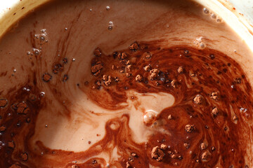 Close up of cocoa powder on top of milk drink