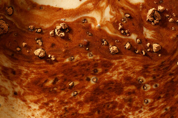 Close up of cocoa powder on top of milk drink