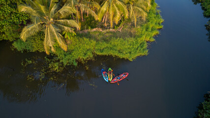 Kayaking tropical island with palm trees and water - Aerial image