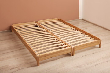 Fototapeta na wymiar Wooden bed frame on floor in room