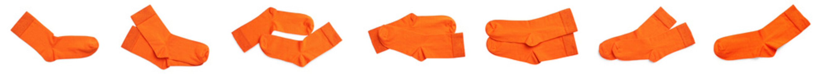 Set with pairs of orange socks on white background, top view. Banner design