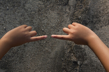 A child's hand with the index finger facing each other.
