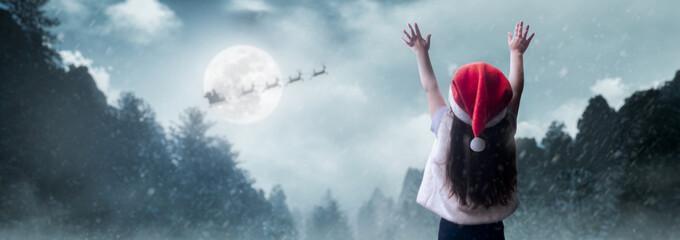 girl waving to santa claus on christmas night