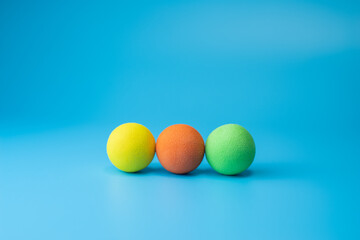 Fototapeta na wymiar Soft foam balls over a blue background,team concept