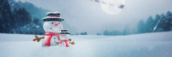 2 happy snowman in the north pole snow on christmas day - concept of father with his son