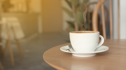 Coffee cup on wood table in cafe background, old wooden table. Simple workspace or morning coffee break.