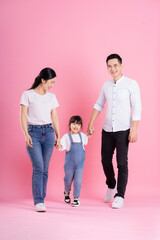 happy young asian family image, isolated on pink background