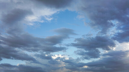 Dark cloud moving in under blue skies