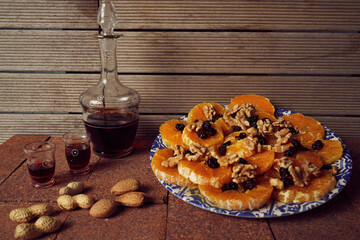 still life of kitchen ingredients eaten with fruits and wine. Oranges and raisins with almonds and walnuts.