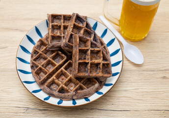 Dessert waffles placed on a wooden table surface