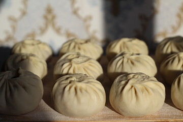 Traditional Buryad Cuisine Food with Chopped Meat and Dough. Preparing Making Dumplings Close-up	
