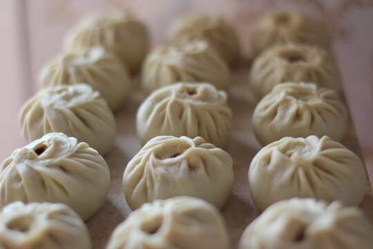 Traditional Buryad Cuisine Food with Chopped Meat and Dough. Preparing Making Dumplings Close-up	
