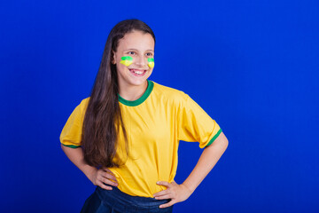 young girl, soccer fan from Brazil. hands on waist