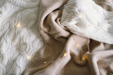 Background with warm sweaters. Pile of knitted clothes, warm background, knitwear, space for text, Autumn winter concept. Copy Space.