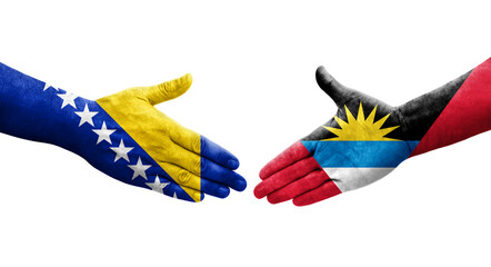Handshake between Antigua and Barbuda and Bosnia flags painted on hands, isolated transparent image.