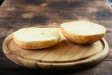 brioche bread, used in sandwich cut on wooden base