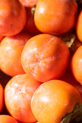 Ripe persimmon fruit background.Close up of fresh kaki