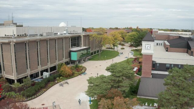 Lansing Community College campus in Lansing, Michigan with drone video moving up.