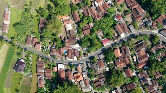 Rooftops Of Traditional Indonesia Village With Road And Green Fields, Aerial Top Down View