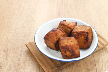 Tahu Bacem, traditional food from Central Java, Indonesia, cooked with spices, palm sugar and coconut water. Boil, then fry briefly.
