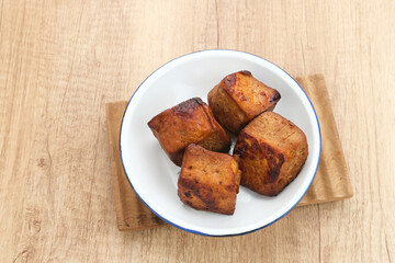 Tahu Bacem, traditional food from Central Java, Indonesia, cooked with spices, palm sugar and coconut water. Boil, then fry briefly.
