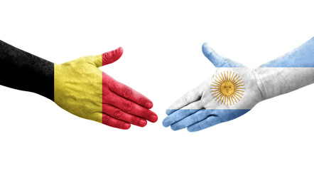 Handshake between Argentina and Belgium flags painted on hands, isolated transparent image.
