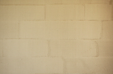 Sand mud wall texture of a Japanese traditional townhouse.  Japanese style background of "Kushibiki" which use a comb.