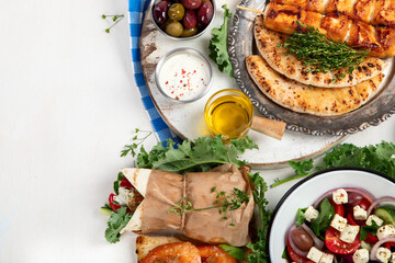 Greek cuisine dishes on neutral background.
