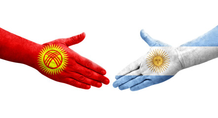 Handshake between Argentina and Kyrgyzstan flags painted on hands, isolated transparent image.