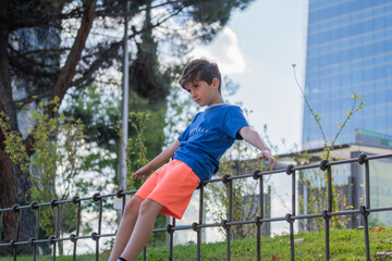 child in a park practicing balance in Madrid downtown centre