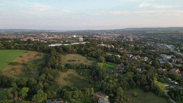 Aerial view flying towards the City of Exeter in Devon, UK on a hazy evening with views from the University to the sea at Exmouth
