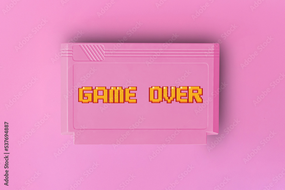 Poster pink 8 bit game cartridge for retro game console on pink background. game over text . minimal concep