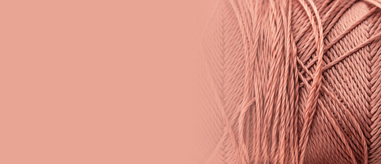 Coral thread, texture, macro, close-up, copy space. A bright banner with a silk thread pattern....