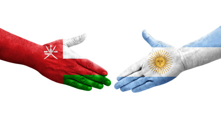 Fototapeta na wymiar Handshake between Argentina and Oman flags painted on hands, isolated transparent image.