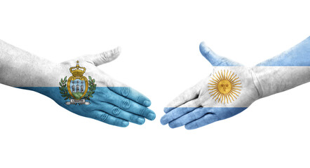 Handshake between Argentina and San Marino flags painted on hands, isolated transparent image.