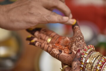 Mumbai, India 13th September 2022: Close-up shots of an Indian bride getting henna also known as...