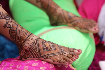 Mumbai, India 13th September 2022: Close-up shots of an Indian bride getting henna also known as...