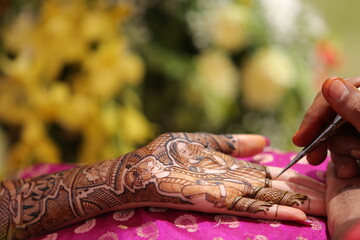Mumbai, India 13th September 2022: Close-up shots of an Indian bride getting henna also known as...