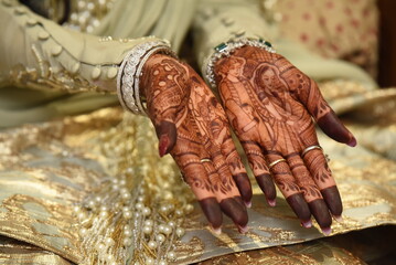 Mumbai, India 13th September 2022: Close-up shots of an Indian bride getting henna also known as...