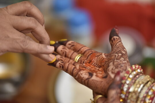 Mumbai, India 13th September 2022: Close-up shots of an Indian bride getting henna also known as Mehendi or mehndi done. Henna pattern. Traditional Rasam or rivaz of done with henna mehandi